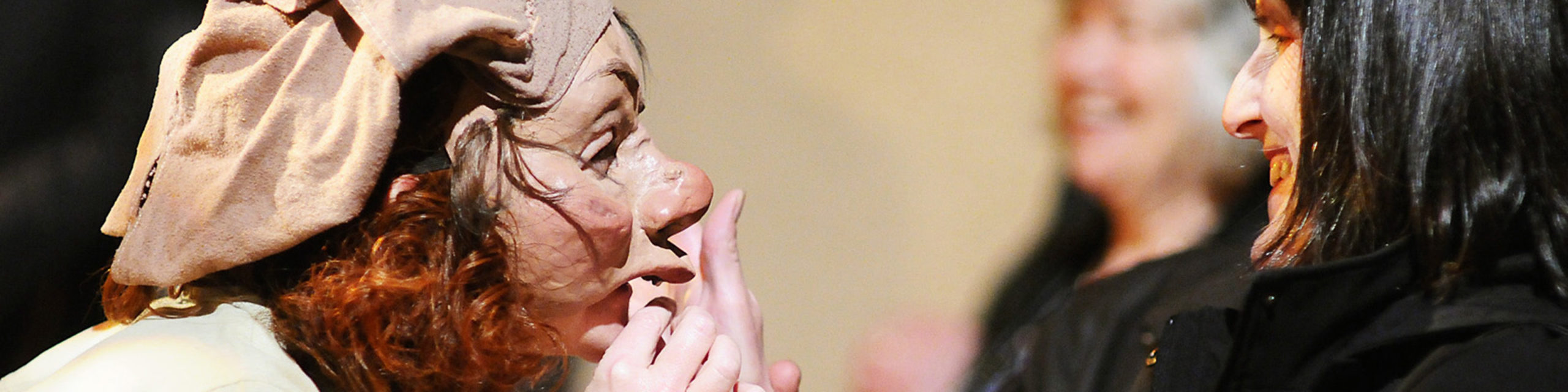 VocalEye's Eileen Barrett gives blind patron Monica Nelson a hands-on feel of a mask used in the play Don Quixote during a Touch Tour at the Surrey Arts Centre.