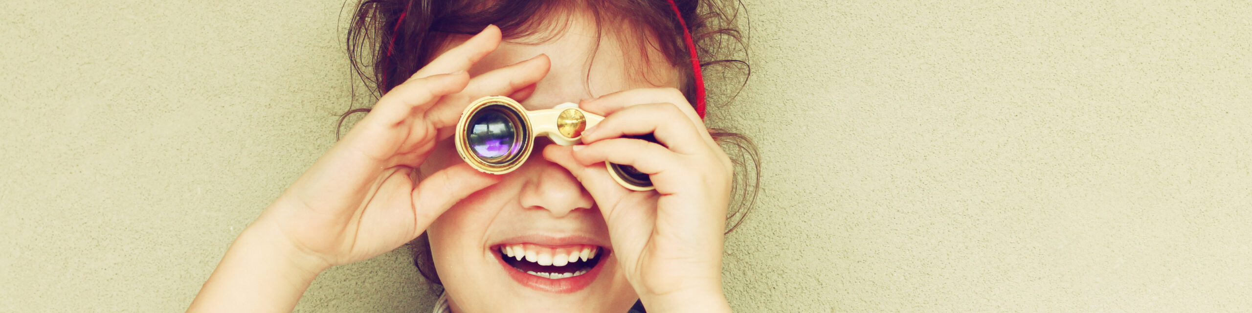 happy youth playing with binoculars